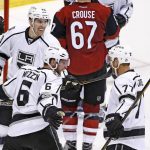 Los Angeles Kings defenseman Jake Muzzin (6) celebrates his goal against the Arizona Coyotes with center Jeff Carter (77) and left wing Tanner Pearson (70) during the third period of an NHL hockey game Tuesday, Jan. 31, 2017, in Glendale, Ariz. The Kings defeated the Coyotes 3-2. (AP Photo/Ross D. Franklin)