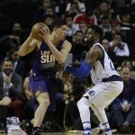Phoenix Suns Devin Booker holds the ball back, under pressure from Dallas Mavericks Wesley Matthews in the first half of their regular-season NBA basketball game in Mexico City, Thursday, Jan. 12, 2017. (AP Photo/Rebecca Blackwell)