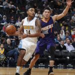 Denver Nuggets guard Gary Harris, left, drives to the basket as Phoenix Suns guard Devin Booker defends in the first half of an NBA basketball game Thursday, Jan. 26, 2017, in Denver. (AP Photo/David Zalubowski)