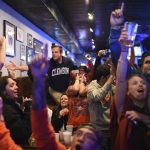 Clemson fans celebrate after a touchdown as they watch television coverage of the NCAA college football playoff championship game between Clemson and Alabama, Monday, Jan. 9, 2017, in Clemson, S.C. (AP Photo/Rainier Ehrhardt)