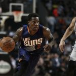 Phoenix Suns Eric Bledsoe, left, dribbles the ball as San Antonio Spurs Danny Green follows him, in the first half of their regular-season NBA basketball game in Mexico City, Saturday, Jan. 14, 2017. (AP Photo/Rebecca Blackwell)