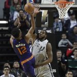 Phoenix Suns TJ Warren goes for a basket as San Antonio Spurs LaMarcus Aldridge attempts to block the ball, in the first half of their regular-season NBA basketball game in Mexico City, Saturday, Jan. 14, 2017. (AP Photo/Rebecca Blackwell)