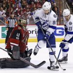Arizona Coyotes goalie Mike Smith (41) looks to make a save as Tampa Bay Lightning center Vladislav Namestnikov (90) and center Brian Boyle (11) try to control the puck during the third period of an NHL hockey game Saturday, Jan. 21, 2017, in Glendale, Ariz. The Coyotes defeated the Lightning 5-3. (AP Photo/Ross D. Franklin)