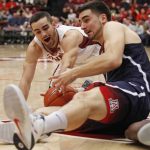 Stanford's Christian Sanders, left, struggles for the ball with Arizona's Dusan Ristic during the first half of an NCAA college basketball game, Sunday, Jan. 1, 2017, in Stanford, Calif. (AP Photo/George Nikitin)