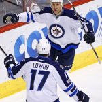 Winnipeg Jets center Shawn Matthias (16) celebrates his goal against the Arizona Coyotes with center Adam Lowry (17) during the first period of an NHL hockey game Friday, Jan. 13, 2017, in Glendale, Ariz. (AP Photo/Ross D. Franklin)