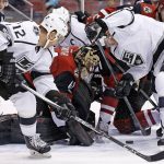 Los Angeles Kings right wing Dustin Brown, right, and right wing Marian Gaborik (12) try to shoot the puck at Arizona Coyotes goalie Mike Smith (41) during the first period of an NHL hockey game, Tuesday, Jan. 31, 2017, in Glendale, Ariz. (AP Photo/Ross D. Franklin)