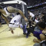Dallas Mavericks Deron Williams returns to the court, along with Phoenix Suns TJ Warren, on the ground, after falling during the first half of their regular-season NBA basketball game in Mexico City, Thursday, Jan. 12, 2017. (AP Photo/Rebecca Blackwell)