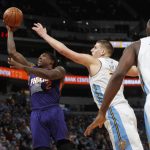Phoenix Suns guard Eric Bledsoe, left, drives to the basket past Denver Nuggets forwards Nikola Jokic, center, of Serbia, and Kenneth Faried in the second half of an NBA basketball game Thursday, Jan. 26, 2017, in Denver. The Nuggets won 127-120. (AP Photo/David Zalubowski)