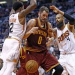 Cleveland Cavaliers forward Kevin Love (0) loses the ball as Phoenix Suns guard Eric Bledsoe (2) and center Tyson Chandler (4) defend during the first half of an NBA basketball game Sunday, Jan. 8, 2017, in Phoenix. (AP Photo/Ross D. Franklin)