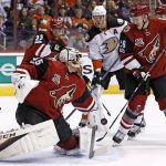 Arizona Coyotes goalie Louis Domingue (35) sends the puck away as Coyotes defenseman Alex Goligoski (33) and defenseman Michael Stone (26) battle for positions with Anaheim Ducks right wing Corey Perry (10) during the first period of an NHL hockey game Saturday, Jan. 14, 2017, in Glendale, Ariz. (AP Photo/Ross D. Franklin)