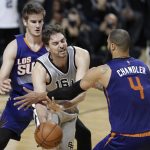 San Antonio Spurs Pau Gaso is confronte by Phoenix Suns Tyson Chandler, right, and Dragan Bender in the second half of their regular-season NBA basketball game in Mexico City, Saturday, Jan. 14, 2017. (AP Photo/Rebecca Blackwell)