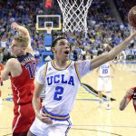 
              UCLA guard Lonzo Ball, center, shoots as Arizona forward Lauri Markkanen, left, and center Chance Comanche defend during the first half of an NCAA college basketball game, Saturday, Jan. 21, 2017, in Los Angeles. (AP Photo/Mark J. Terrill)
            