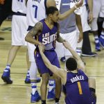 Phoenix Suns Tyler Ulis helps up teammate Devin Booker after losing to the Dallas Mavericks in a regular-season NBA basketball game in Mexico City, Thursday, Jan. 12, 2017. (AP Photo/Rebecca Blackwell)