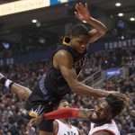 Phoenix Suns' Brandon Knight, top, fouls Toronto Raptors' DeMarre Carroll during first-half NBA basketball game action in Toronto, Sunday, Jan. 22, 2017. (Chris Young/The Canadian Press via AP)