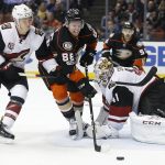Anaheim Ducks' Ondrej Kase (86) moves in on Arizona Coyotes goalie Mike Smith (41) as Coyotes' Jakob Chychrun (6) defends in the second period of an NHL hockey game in Anaheim, Calif., Friday, Jan. 6, 2017. (AP Photo/Christine Cotter)