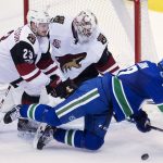 Arizona Coyotes defenceman Oliver Ekman-Larsson (23) tries to clear Vancouver Canucks left wing Daniel Sedin (22) from in front of Arizona Coyotes goalie Mike Smith (41) during second period NHL hockey action in Vancouver, British Columbia, Wednesday, Jan. 4, 2017. (Jonathan Hayward/The Canadian Press via AP)