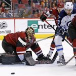 Arizona Coyotes goalie Mike Smith, left, makes a save on a shot as Winnipeg Jets right wing Blake Wheeler (26) battles for position with Coyotes defenseman Luke Schenn (2) and defenseman Oliver Ekman-Larsson (23) during the second period of an NHL hockey game Friday, Jan. 13, 2017, in Glendale, Ariz. (AP Photo/Ross D. Franklin)