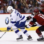 Tampa Bay Lightning left wing Jonathan Drouin (27) skates with the puck against Arizona Coyotes center Christian Dvorak (18) and left wing Brendan Perlini, right, during the first period of an NHL hockey game Saturday, Jan. 21, 2017, in Glendale, Ariz. (AP Photo/Ross D. Franklin)