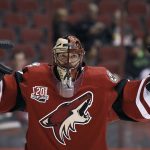 FILE - In this Dec. 27, 2016, file photo, Arizona Coyotes goalie Mike Smith stretches before the team's NHL hockey game against the Dallas Stars,  in Glendale, Ariz. Mike Smith felt weird that other teams were playing while he and the Arizona Coyotes were off and relaxing, but that didn't deter the All-Star goaltender from going sledding with his kids and taking advantage of the downtime. (AP Photo/Ralph Freso, File)