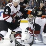 Anaheim Ducks' Ondrej Kase (86) battles Arizona Coyotes' Jakob Chychrun (6) as Arizona goalie Mike Smith defends the net in the second period of an NHL hockey game in Anaheim, Calif., Friday, Jan. 6, 2017. (AP Photo/Christine Cotter)