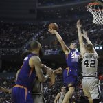 Phoenix Suns Devin Booker, second right, drives for a basket San Antonio Spurs Davis Bertrans right, attempts to block him, in the first half of their regular-season NBA basketball game in Mexico City, Saturday, Jan. 14, 2017. (AP Photo/Rebecca Blackwell)