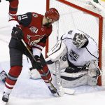 Los Angeles Kings goalie Peter Budaj, right, makes a save on a deflection by Arizona Coyotes center Martin Hanzal (11) during the third period of an NHL hockey game Tuesday, Jan. 31, 2017, in Glendale, Ariz. The Kings defeated the Coyotes 3-2. (AP Photo/Ross D. Franklin)