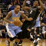 Phoenix Suns guard Eric Bledsoe (2) draws the offensive foul against Denver Nuggets guard Jameer Nelson in the first quarter during an NBA basketball game, Saturday, Jan. 28, 2017, in Phoenix. (AP Photo/Rick Scuteri)