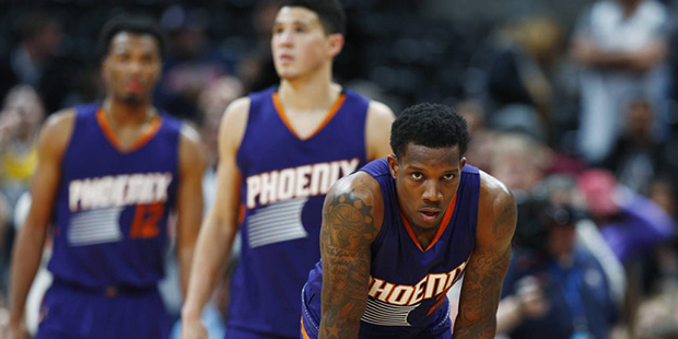Phoenix Suns guards Eric Bledsoe, front, and Devin Booker, center, and forward TJ Warren (12) react...