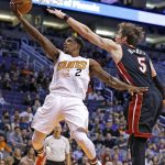 Phoenix Suns guard Eric Bledsoe (2) drives past Miami Heat forward Luke Babbitt (5) during the first half of an NBA basketball game Tuesday, Jan. 3, 2017, in Phoenix. (AP Photo/Ross D. Franklin)