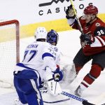 Arizona Coyotes right wing Christian Fischer (36) scores in his first NHL hockey game as the gets the puck past Tampa Bay Lightning defenseman Victor Hedman (77) and goalie Ben Bishop during the second period Saturday, Jan. 21, 2017, in Glendale, Ariz. (AP Photo/Ross D. Franklin)
