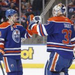Edmonton Oilers' Kris Russell (4) and goalie Cam Talbot (33) celebrate the win over the Arizona Coyotes in an NHL hockey game in Edmonton, Alberta, Monday, Jan. 16, 2017. (Jason Franson/The Canadian Press via AP)