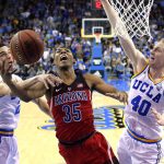 
              Arizona guard Allonzo Trier, center, shoots as UCLA guard Lonzo Ball, left, and center Thomas Welsh defend during the second half of an NCAA college basketball game, Saturday, Jan. 21, 2017, in Los Angeles. Arizona won 96-85. (AP Photo/Mark J. Terrill)
            