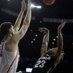 Colorado guard Bryce Peters (23) shoots over Arizona center Dusan Ristic during the first half of an NCAA college basketball game, Saturday, Jan. 7, 2017, in Tucson, Ariz. (AP Photo/Rick Scuteri)