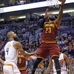 Cleveland Cavaliers forward LeBron James (23) drives past Phoenix Suns center Tyson Chandler (4) for a score during the first half of an NBA basketball game Sunday, Jan. 8, 2017, in Phoenix. (AP Photo/Ross D. Franklin)