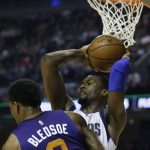 Dallas Mavericks Harrison Barnes holds on to the ball behind Phoenix Suns Eric Bledsoe in the first half of their regular-season NBA basketball game in Mexico City, Thursday, Jan. 12, 2017. (AP Photo/Rebecca Blackwell)