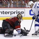 Arizona Coyotes goalie Mike Smith, left, makes a save on a shot by Tampa Bay Lightning center Cedric Paquette (13) during the third period of an NHL hockey game Saturday, Jan. 21, 2017, in Glendale, Ariz. The Coyotes defeated the Lightning 5-3. (AP Photo/Ross D. Franklin)
