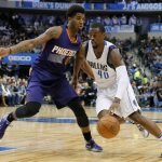 Phoenix Suns' Marquese Chriss (0) guards against a move to the basket by Dallas Mavericks' Harrison Barnes (40) in the first half of an NBA basketball game, Thursday, Jan. 5, 2017, in Dallas. (AP Photo/Tony Gutierrez)