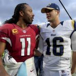 Arizona Cardinals wide receiver Larry Fitzgerald, left, greets Los Angeles Rams quarterback Jared Goff on the field after the Cardinals won an NFL football game Sunday, Jan. 1, 2017, in Los Angeles. (AP Photo/Mark J. Terrill)