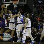 Phoenix Suns P.J. Tucker holds on to the ball as Dallas Mavericks Dirk Nowitzki, second from left, and his teammate Salah Mejri collide during the first half of their regular-season NBA basketball game in Mexico City, Thursday, Jan. 12, 2017. (AP Photo/Rebecca Blackwell)