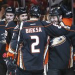 Anaheim Ducks' Chris Wagner, right, is congratulated by teammates Kevin Bieksa (2) and Jared Boll (40) after scoring a goal in the second period of an NHL hockey game against the Arizona Coyotes in Anaheim, Calif., Friday, Jan. 6, 2017. (AP Photo/Christine Cotter)