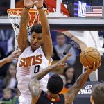 Phoenix Suns forward Marquese Chriss (0) fouls Miami Heat forward Udonis Haslem (40) as Haslem goes up for a shot during the first half of an NBA basketball game Tuesday, Jan. 3, 2017, in Phoenix. (AP Photo/Ross D. Franklin)