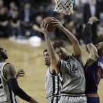 San Antonio Spurs Pau Gasol, center, fights for a rebound with Phoenix Suns Tyson Chandler, right, as teammates San Antonio Spurs LaMarcus Aldridge, left, and San Antonio Spurs Danny Green look on, in the second half of their regular-season NBA basketball game in Mexico City, Saturday, Jan. 14, 2017. (AP Photo/Rebecca Blackwell)