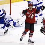 Arizona Coyotes defenseman Michael Stone, second from right, celebrates his goal against Tampa Bay Lightning goalie Ben Bishop, second from left, as Lightning defenseman Anton Stralman (6) skates away and Coyotes center Martin Hanzal (11) looks for the puck during the second period of an NHL hockey game Saturday, Jan. 21, 2017, in Glendale, Ariz. (AP Photo/Ross D. Franklin)