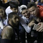 San Antonio Spurs LaMarcus Aldridge has a picture taken with fans prior a game agains the Phoenix Suns at Mexico City Arena in Mexico City, Saturday, Jan. 14, 2017. (AP Photo/Rebecca Blackwell)