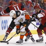 Anaheim Ducks right wing Jakob Silfverberg (33) keeps the puck away from Arizona Coyotes defenseman Connor Murphy (5) and center Martin Hanzal (11) during the first period of an NHL hockey game Saturday, Jan. 14, 2017, in Glendale, Ariz. (AP Photo/Ross D. Franklin)