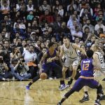Phoenix Suns Marquese Chriss,left, dribbles the ball past San Antonio Spurs David Lee, second left, and Manu Ginobili try to stop him, in the first half of their regular-season NBA basketball game in Mexico City, Saturday, Jan. 14, 2017. (AP Photo/Rebecca Blackwell)