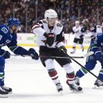 Arizona Coyotes left wing Brendan Perlini (29) tries to get past Vancouver Canucks defenseman Alexander Edler (23) and Vancouver Canucks left wing Sven Baertschi (47) during the first period of an NHL hockey game, Wednesday, Jan. 4, 2017 in Vancouver, British Columbia. (Jonathan Hayward/The Canadian Press via AP)