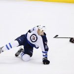 Winnipeg Jets center Shawn Matthias (16) gets tripped up by Arizona Coyotes defenseman Jakob Chychrun (6) during the first period of an NHL hockey game Friday, Jan. 13, 2017, in Glendale, Ariz. (AP Photo/Ross D. Franklin)
