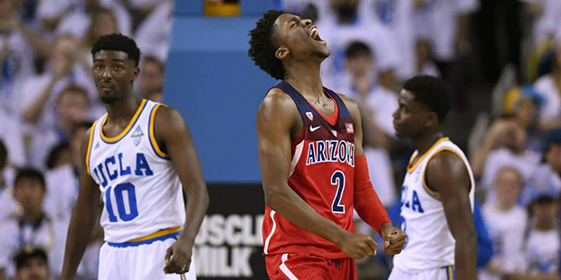 Arizona guard Kobi Simmons, center, celebrates after scoring as UCLA guard Isaac Hamilton, left, an...