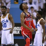 
              Arizona guard Kobi Simmons, center, celebrates after scoring as UCLA guard Isaac Hamilton, left, and guard Aaron Holiday stand in the background during the second half of an NCAA college basketball game, Saturday, Jan. 21, 2017, in Los Angeles. Arizona won 96-85. (AP Photo/Mark J. Terrill)
            